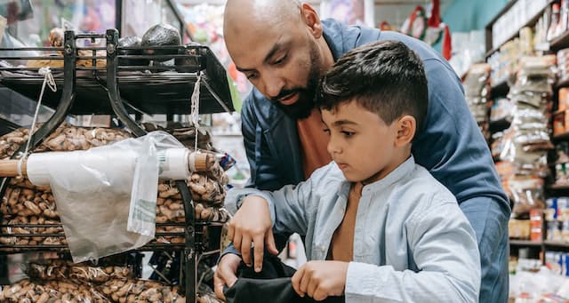 Father helping son eat healthy