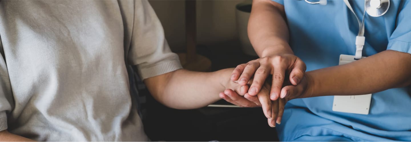 Patient and nurse holding hands