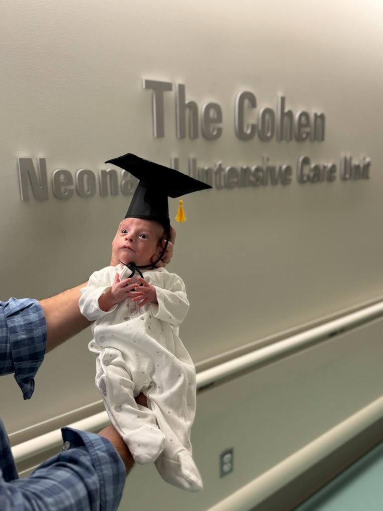 baby wearing a graduation hat