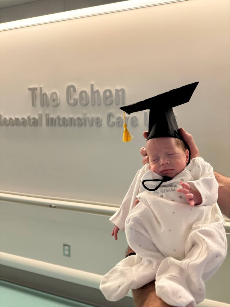 baby wearing a graduation hat