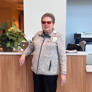 woman standing next to the reception desk