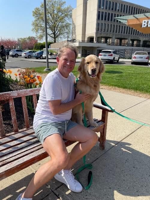man sitting on a bench with a dog