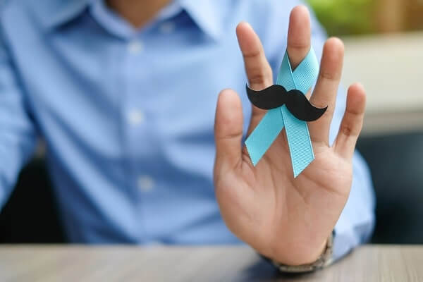 man holding a blue ribbon