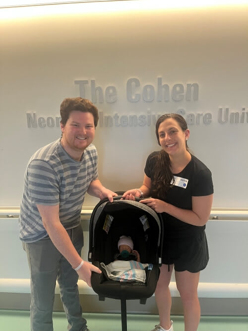 mom and dad with newborn baby