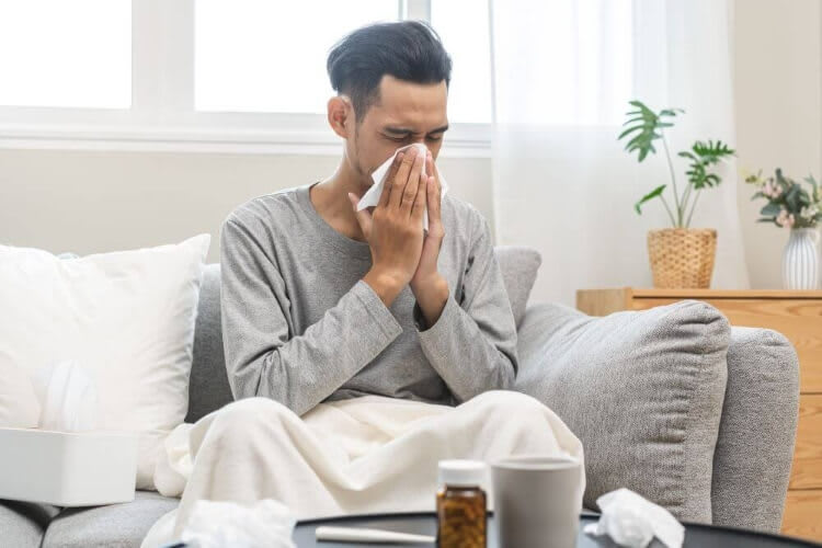 man blowing his nose