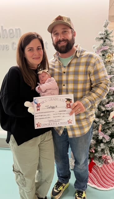 a couple holding their baby