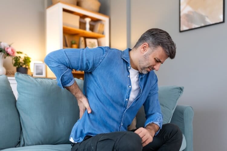 man holding his back