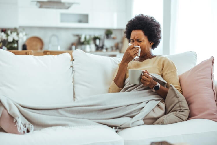 sick woman sitting on the couch