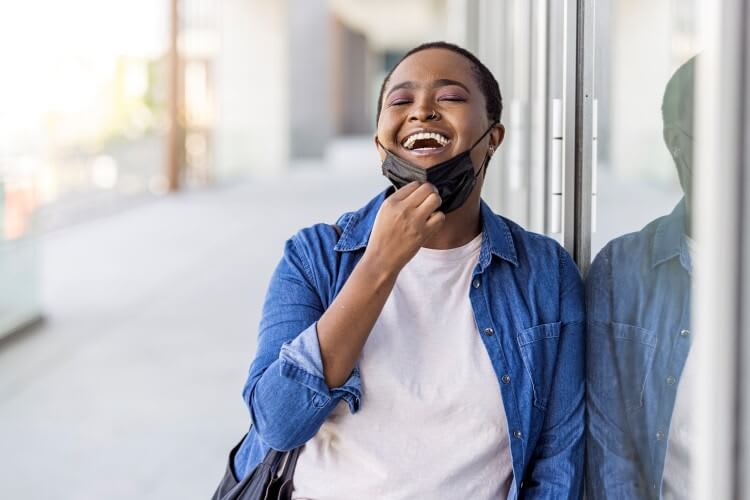 woman removing mask