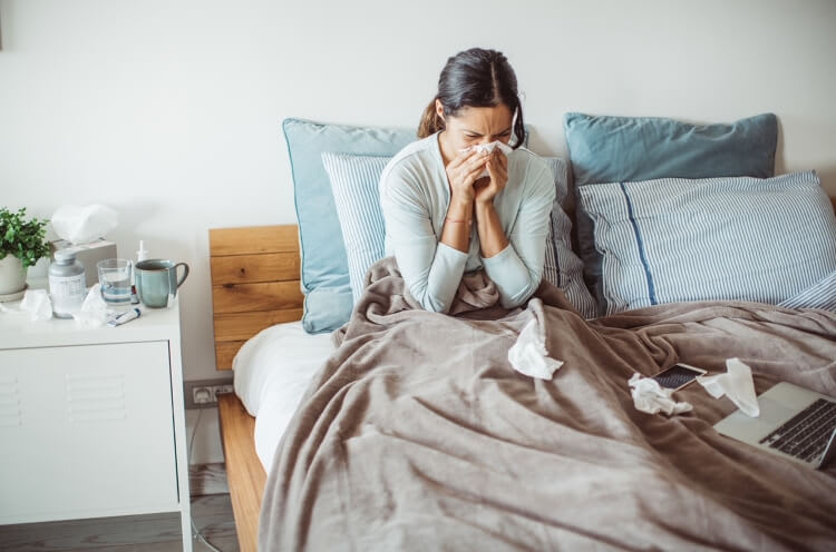 woman sick in bed