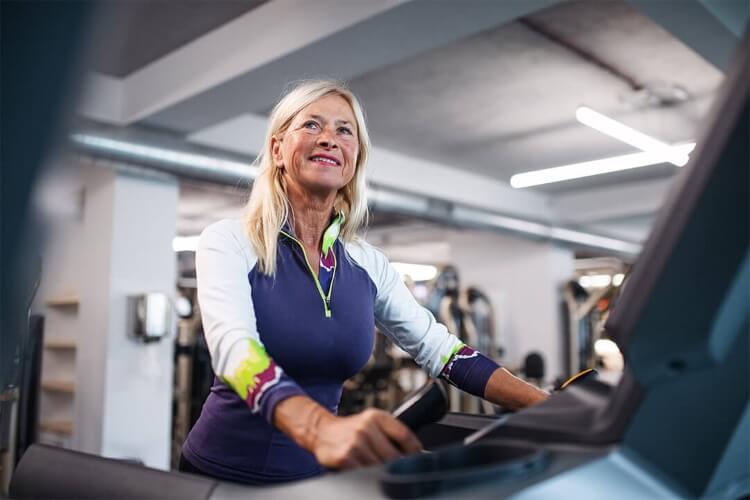 a woman walking on a treadmill