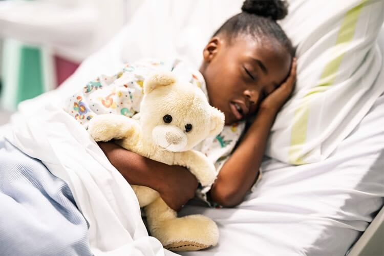 a child hugging a teddy bear