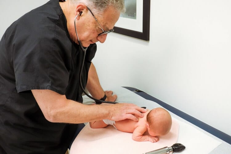 pediatrician checking a baby