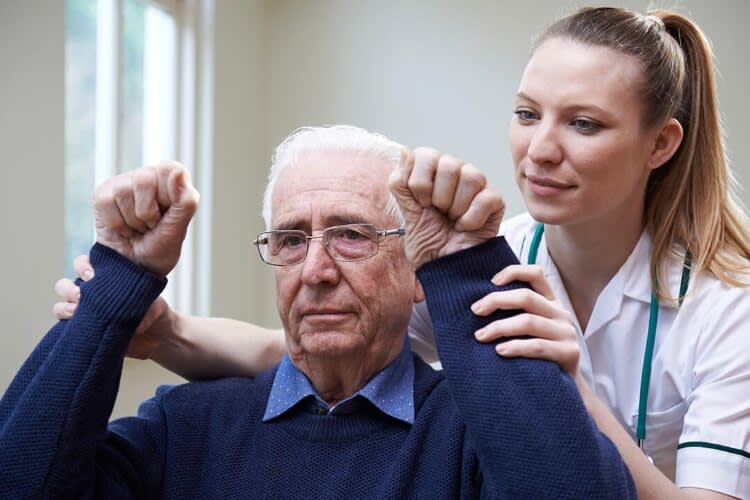 nurse assisting an elderly patient