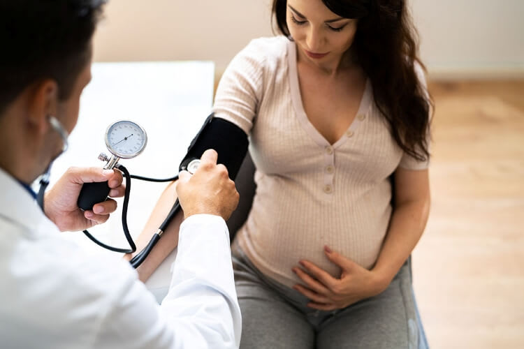 pregnant woman getting her blood pressure checked