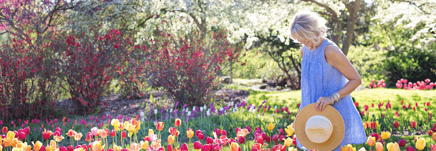 woman walking through a field of flowers