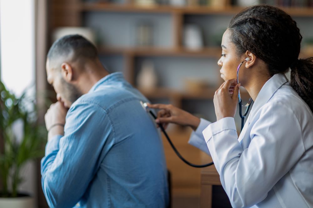 Doctor examines patient and listens to lungs