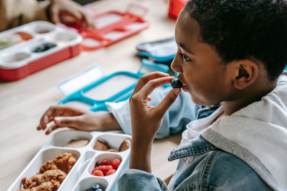 Kid eating a fruit