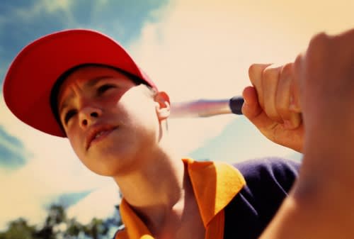 Boy batting baseball