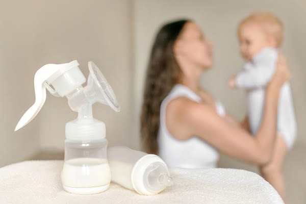 Milk in breast pump, mom and baby