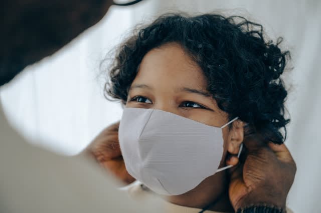 Child wearing face mask, smiling