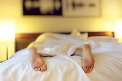 Feet hanging off bed