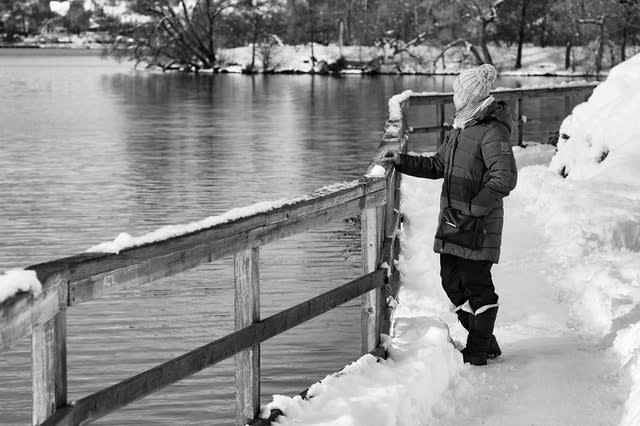 Man outside on bridge in winter, pondering the meaning of life